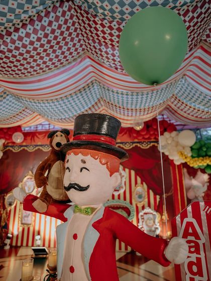 A close-up of a custom-made ringmaster prop, complete with a friendly bear on his shoulder. These handcrafted details add personality and charm, making the event feel personal and unique.