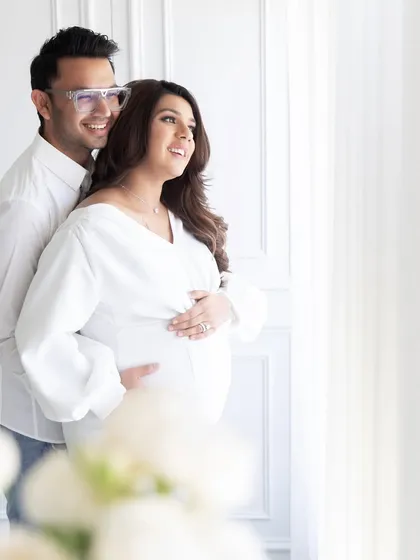 A beautiful moment from a maternity session, showcasing the soft, natural light that floods the studio. The serene, all-white environment is perfect for capturing intimate and timeless family and maternity portraits.