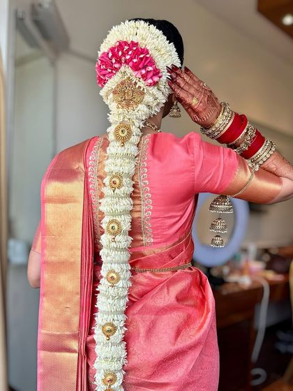 The stunning details of the bridal hairstyle. A traditional South Indian floral braid, or 'poola jada', is a work of art in itself and a key element of the overall bridal look.