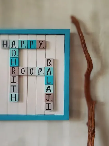 For the family that loves games and words. This custom Scrabble-themed name board is a playful and classy way to display your family names, set in a beautiful teal wooden frame.