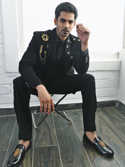 I styled this all-black, embellished suit for a men's couture campaign. The military-inspired details and sharp tailoring create a powerful and formal look, perfect for a groom or special occasion.