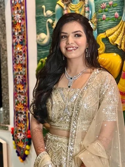 A smiling shot of this client, her diamond necklace and glowing makeup shining bright.