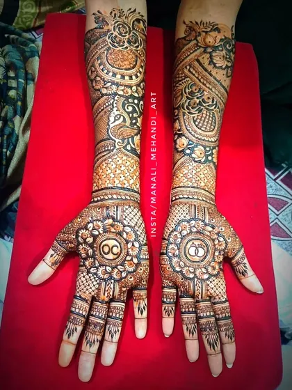 This design combines traditional peacock figures with modern personalization. I included the couple's initials 'OC' inside a circular mandala on the palm, surrounded by detailed floral and checkerboard patterns.