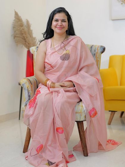 This soft pink hand-painted organza saree is so delicate and pretty. It's a perfect choice for a daytime event or a summer festival.