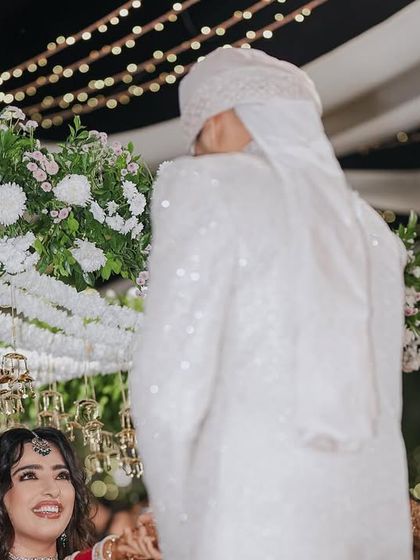 The bride's "phoolon ki chaadar" (floral canopy) is a sacred and beautiful part of her entrance. We designed this one with a dense arrangement of white flowers and hanging kaleeras.