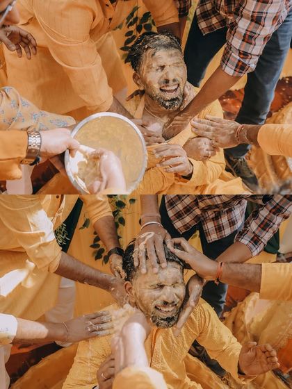 A collage showing the groom being playfully covered in haldi paste by his friends.