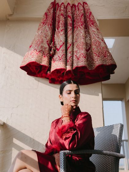 An artistic shot with her bridal lehenga. This image captures the anticipation and excitement of the moments before she gets dressed for her big day.