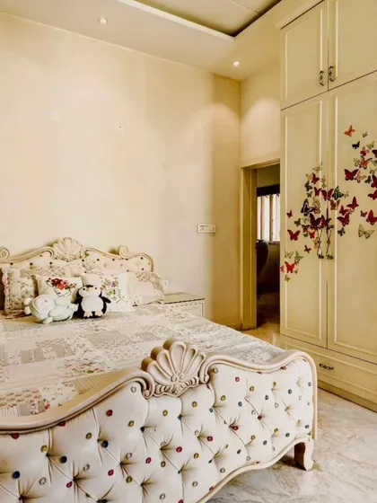 Another view of the kids' room from image 56, showing the butterfly decals on the wardrobe.