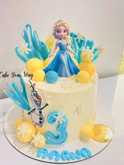 A magical Frozen cake for Aarna's 3rd birthday, featuring Elsa, Olaf, and chocolate snowflakes.