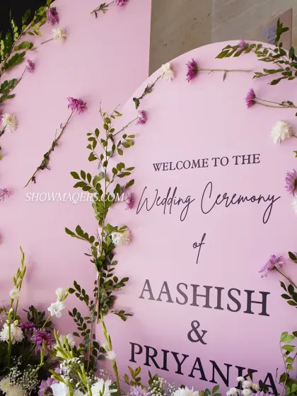 A close-up of a personalized welcome sign for a wedding ceremony, with delicate floral decorations.