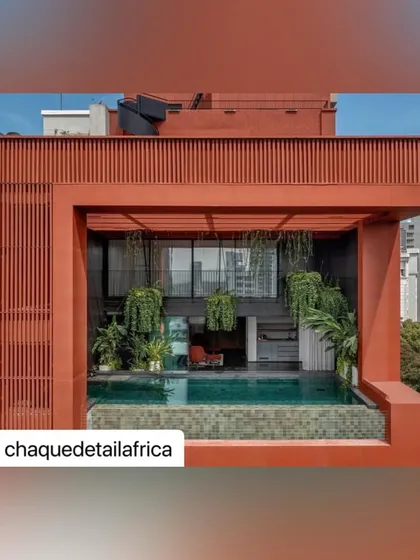 A closer look at the rooftop pool area of the Sarvasva tower. The space is framed by a terracotta screen and lush hanging plants, creating a private, resort-like atmosphere with a view of the city.