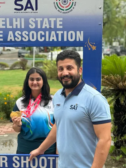Another proud photo with a student and her gold medal at the Delhi State Rifle Association event. My direct involvement ensures every shooter gets the guidance they need.