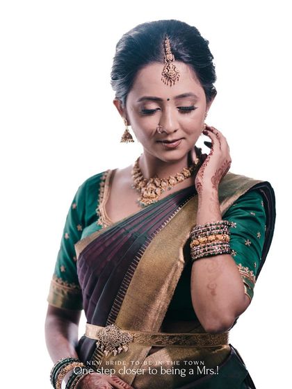 A portrait of a bride-to-be in a beautiful green and purple saree, highlighting her elegance.