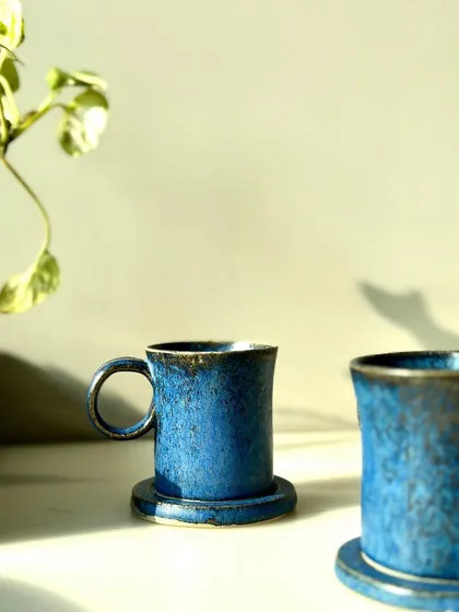 A set of our limited edition cobalt blue mugs with matching coasters. They are inspired by natural forms and contemporary design.
