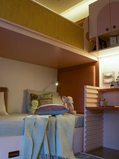 Soft toys are essential for bringing warmth and comfort to a child's bedroom. This bunk bed setup with a built-in desk is adorned with cuddly companions, creating a playful space for adventure and sweet dreams.