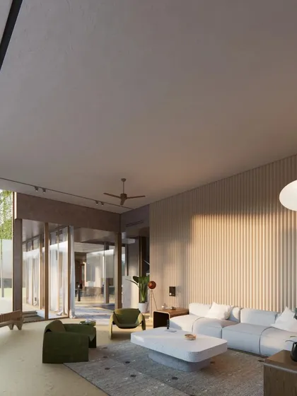 The living room of the Sanctuary Residence is designed with pivoting glass doors that open completely to the garden, blurring the boundary between inside and out.