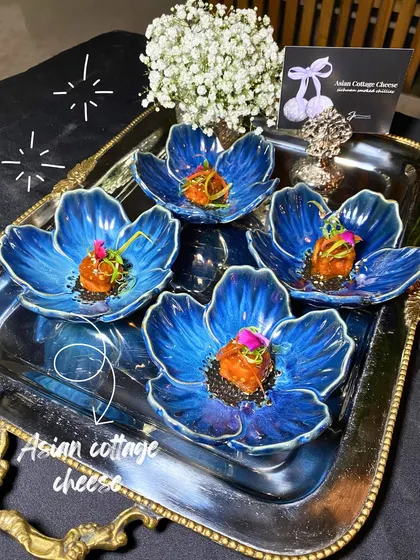 Asian Cottage Cheese appetizers, beautifully presented in stunning blue flower-shaped bowls for a 25th birthday celebration.