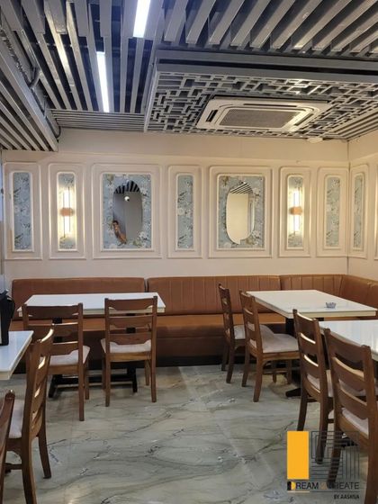 At Rigo Restaurant, I used classic wall molding and a mix of seating styles to create a timeless and elegant dining room. The design balances traditional elements with a clean, modern sensibility.
