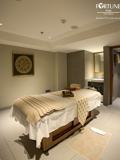A wider view of a private treatment room, showing the attached personal washroom area. I ensure you have everything you need for a comfortable and seamless spa experience.