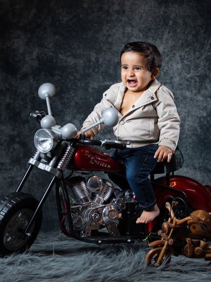 Born to be wild! This little biker in a leather jacket is ready to hit the road on his miniature motorcycle. A perfect concept for a baby with a bit of attitude.