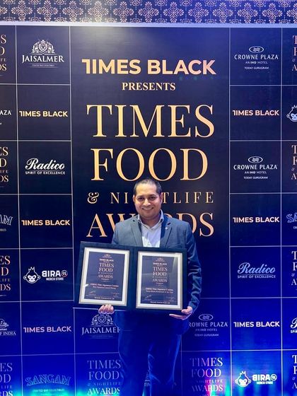 One of our senior team members with the awards. We are grateful for the hard work and passion that every individual brings to our restaurant and catering services.