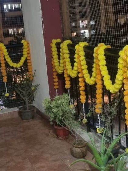 Traditional marigold garlands decorating a balcony for a festive occasion.