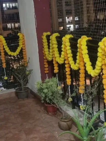 Traditional marigold garlands decorating a balcony for a festive occasion.
