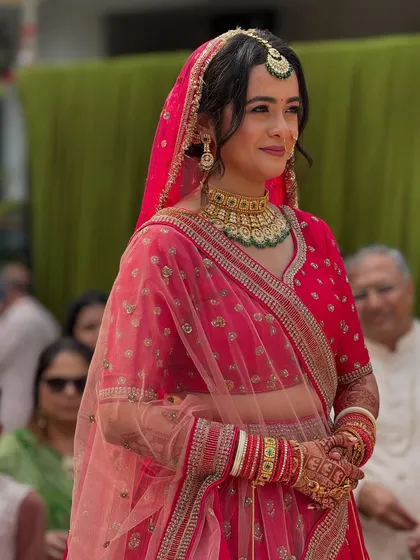 A candid moment from the phera ceremony, showing the bride in her beautiful pink lehenga and traditional jewellery.