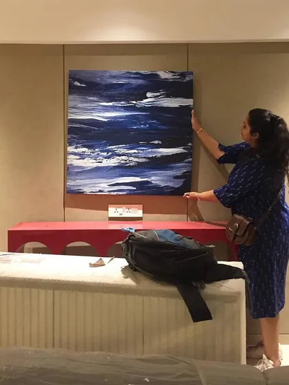A personal touch from our principal designer, Twisha, as she adjusts the artwork at the 'Vishu Home' project. This hands-on approach ensures every detail aligns with our creative vision.