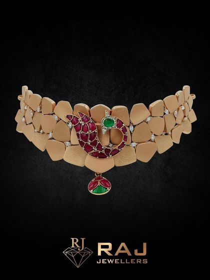 This modern choker design features a unique textured gold band with a central paisley motif in red and green. It's a perfect fusion piece, blending contemporary style with a hint of traditional Indian symbolism.