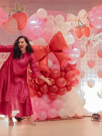Full of energy at my daughter Gauri's first birthday party. The 'Berry Sweet' theme with a giant balloon arch created a magical backdrop for the celebration.
