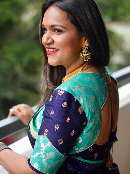 Our client Supritha in an elegantly crafted, custom-fit brocade mix-and-match blouse in shades of navy blue and turquoise.