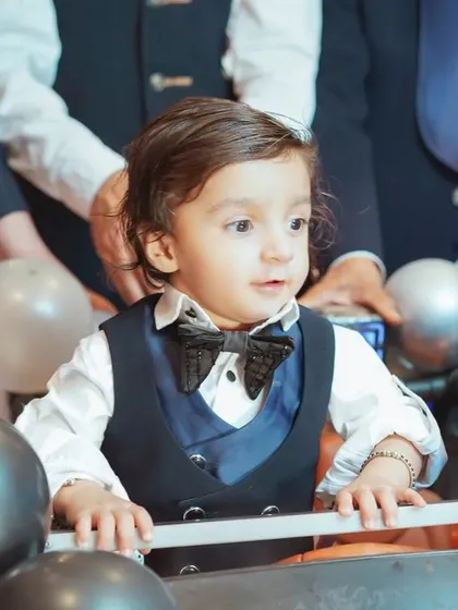 It's these unscripted, in-between moments that are pure magic. We focus on capturing your child's genuine expressions and personality, like this little one's curious gaze during his grand birthday entrance.