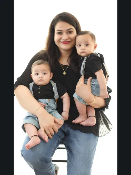 A mother's arms full of love with her six-month-old twin boys. Capturing portraits with twins is a special joy, and I love showcasing their individual personalities.