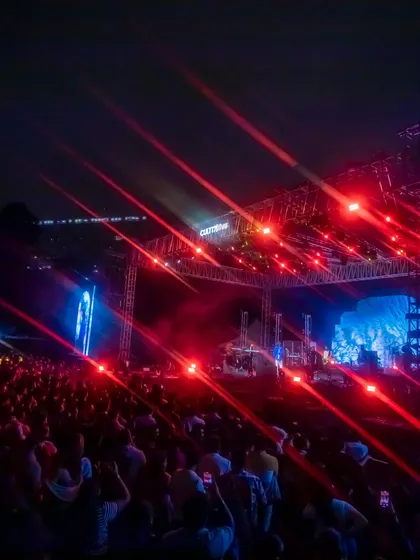 A shot of the massive lighting rig we designed for the concert. We also secure and manage strategic festival partnerships, like this collaboration with Hell Energy Drink, integrating sponsors seamlessly into the event experience.