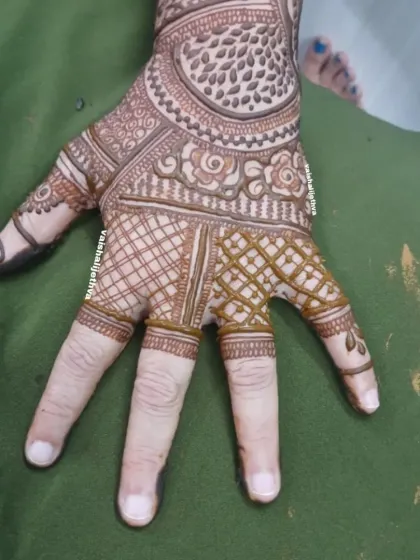 A section of a back-hand design. This image highlights the combination of checkered patterns and floral motifs on the palm.