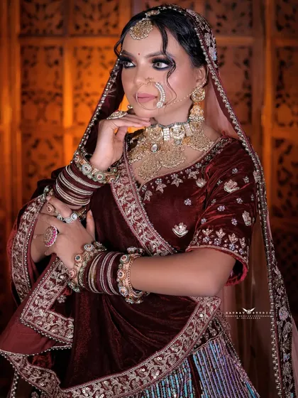 A classic portrait pose, with the bride's hand gently resting on her chin, exuding elegance.