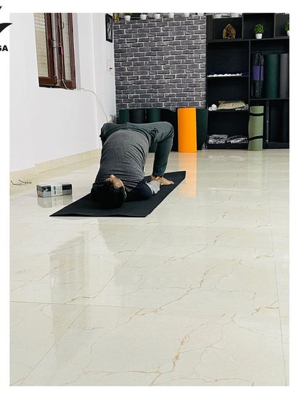 A student practices Setu Bandhasana, or Bridge Pose, a foundational backbend that strengthens the back and opens the chest. This is a key preparation for deeper backbends.