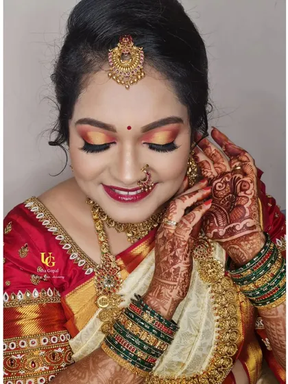 This look is for those who love color and glitter. I teach how to create a warm, sunset-inspired eye with sharp winged liner, a technique that makes the eyes the star of the show for any muhurtham or festive event.