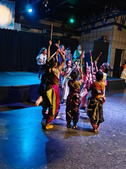 Another angle of the energetic folk dance, showcasing the colorful costumes and joyful movements of the children. It’s a celebration of movement and culture on the Vyoma stage.