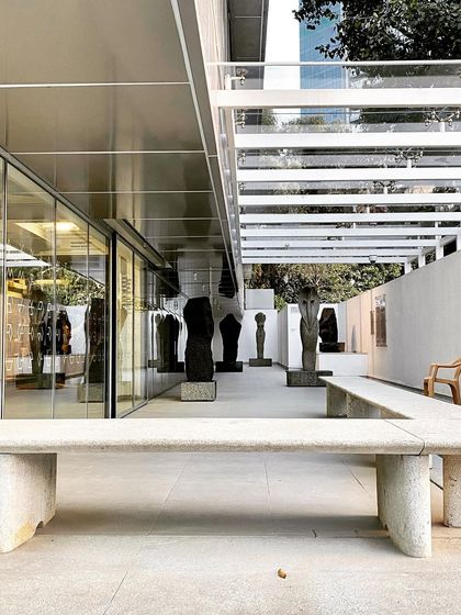 A stone bench in the outdoor gallery of MAP. We use honest, robust materials to create durable and inviting public furniture that is integrated into the overall architectural language.