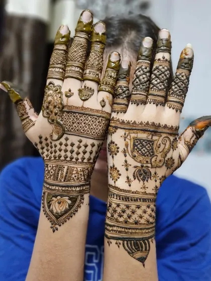 A playful pose showing the back of the hands, which feature simpler, elegant versions of the traditional motifs on the palms.