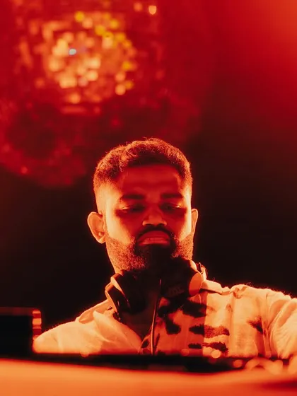 A close-up, artistic shot of me under red light, with a disco ball creating a beautiful bokeh effect.