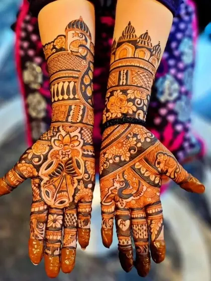 Architectural motifs inspired by Rajasthani palaces adorn the arms in this design. The palms feature a swastika and other auspicious symbols, making it perfect for a traditional wedding ceremony.