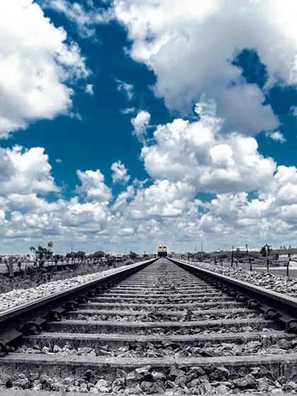 I love the feeling of a journey about to begin. I used a special editing style here to make the blue sky and white clouds pop against the monochrome railway tracks, leading your eye toward the horizon.