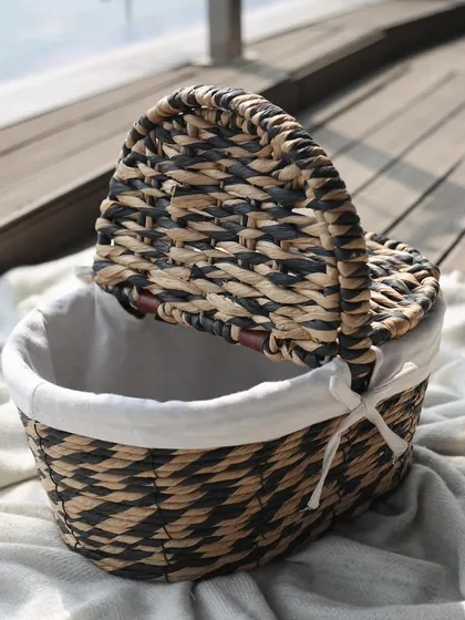 This woven basket with a black and natural pattern and a convenient lid is a chic storage solution. It’s perfect for hiding away clutter while adding a touch of bohemian elegance.
