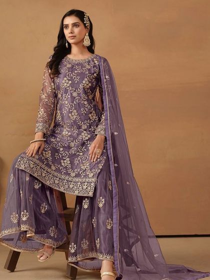 This purple net salwar kameez with sharara pants is a festive dream. The all-over sequence and thread work make it sparkle from every angle.