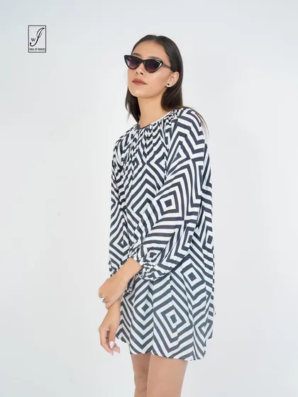 A black and white geometric print dress, shot to emphasize its bold pattern and simple silhouette.