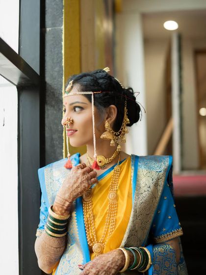 A beautiful window-lit portrait of the bride, lost in thought, creating a soft and timeless look.