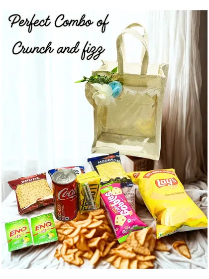 The perfect combo of crunch and fizz. This image shows all the contents of the Crunchy Hamper, including a variety of chips, snacks, and drinks.